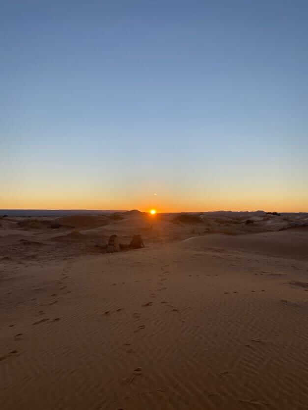 Sunrise over Erg Chebbi dunes near desert camp during 2 nights camel trekking in Merzouga